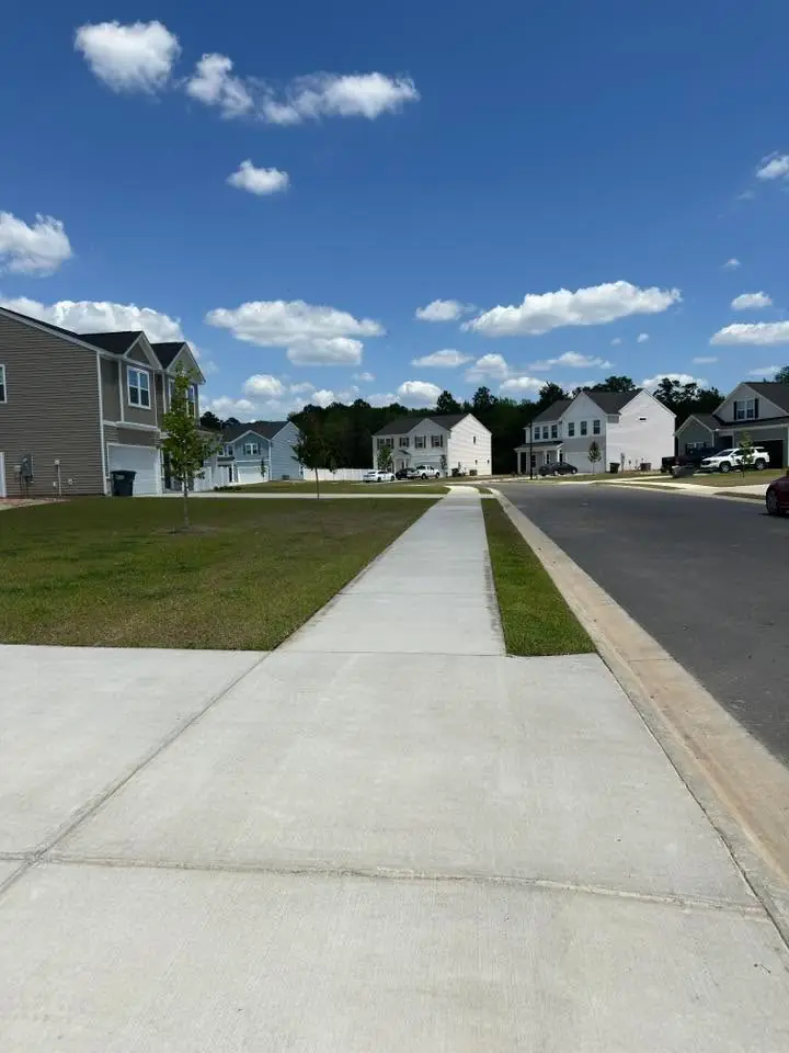 Defined lawn edges along a cleared sidewalk and curb at a Platinum Lawncare project