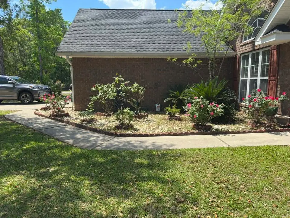 Lawn, shrubs, and a curved garden walkway at a Platinum Lawncare project